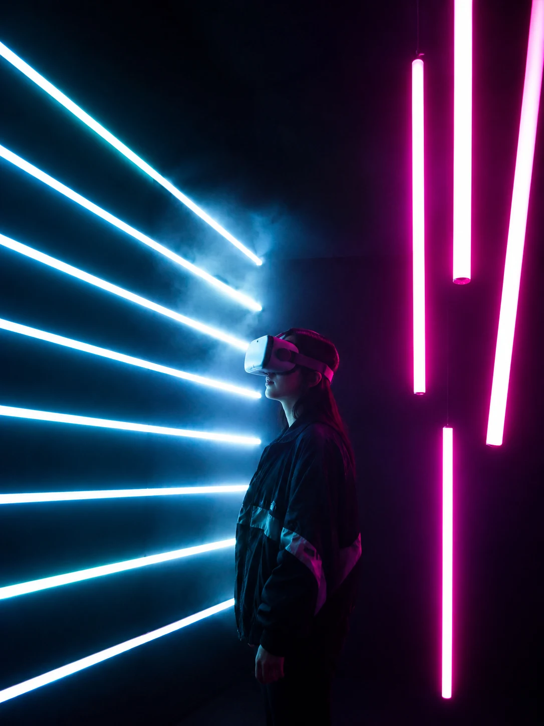 Learner experiencing immersive VR education with cyan and magenta neon lighting